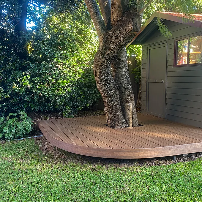 Timber deck opening onto a planted garden
